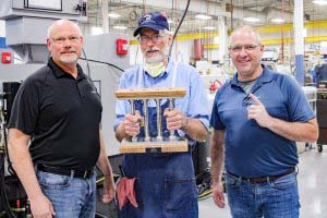 June Pillar Among Peers Recipient, Dave T., pictured with President Mike J. Reader and COO Dave Strand